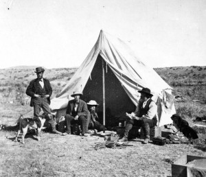 Frank Bradley, in tent, relaxes with his colleagues in Yellowstone National Park during an 1872 geological expedition. Bradley reported hearing strange sounds along the shore of Yellowstone Lake. (USGS photo - click to enlarge)
