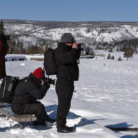 Photographers in Yellowstone National Park snap pictures in January during an eruption of Old Faithful geyser. (Ruffin Prevost/Yellowstone Gate - click to enlarge)