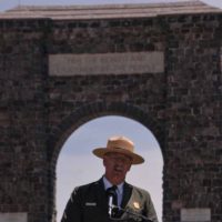 Yellowstone National Park Superintendent Dan Wenk speaks Thursday in front of the Roosevelt Arch during a kickoff event for a project that will reconfigure the North Entrance to the park. (Ruffin Prevost/Yellowstone Gate - click to enlarge)