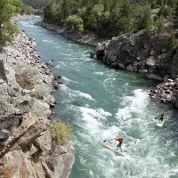 Two adventurers try their luck on stand-up paddleboards in Yankee Jim Canyon, north of Gardiner, Mont. (Montana Tourism photo)