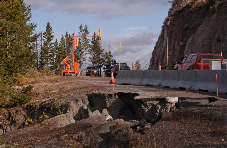 Traffic in 2012 moves along a single lane of the then-damaged road between Sylvan Pass and Fishing Bridge in Yellowstone National Park. 