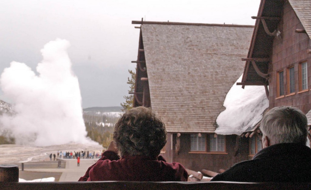 Visitors watch Old Faithful geyser erupt from a second-floor observation deck at the Old Faithful Inn. (Ruffin Prevost/Yellowstone Gate - click to enlarge)