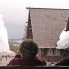 Visitors watch Old Faithful geyser erupt from a second-floor observation deck at the Old Faithful Inn. (Ruffin Prevost/Yellowstone Gate - click to enlarge)