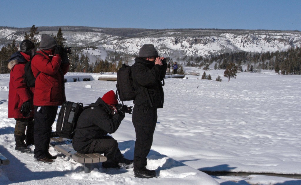 Photographers in Yellowstone National Park snap pictures in January during an eruption of Old Faithful geyser. (Ruffin Prevost/Yellowstone Gate - click to enlarge)