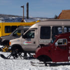 Snow coaches are parked near the Old Faithful Visitor Center in Yellowstone National Park.