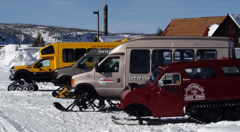 Snow coaches are parked near the Old Faithful Visitor Center in Yellowstone National Park.