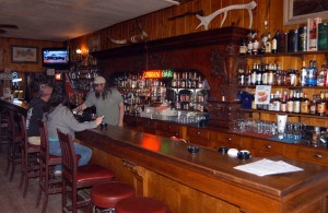A historic Brunswick bar built nearly 120 years ago is the centerpiece of the Cowboy Bar in Meeteetse, Wyo. (Ruffin Prevost/Yellowstone Gate - click to enlarge)