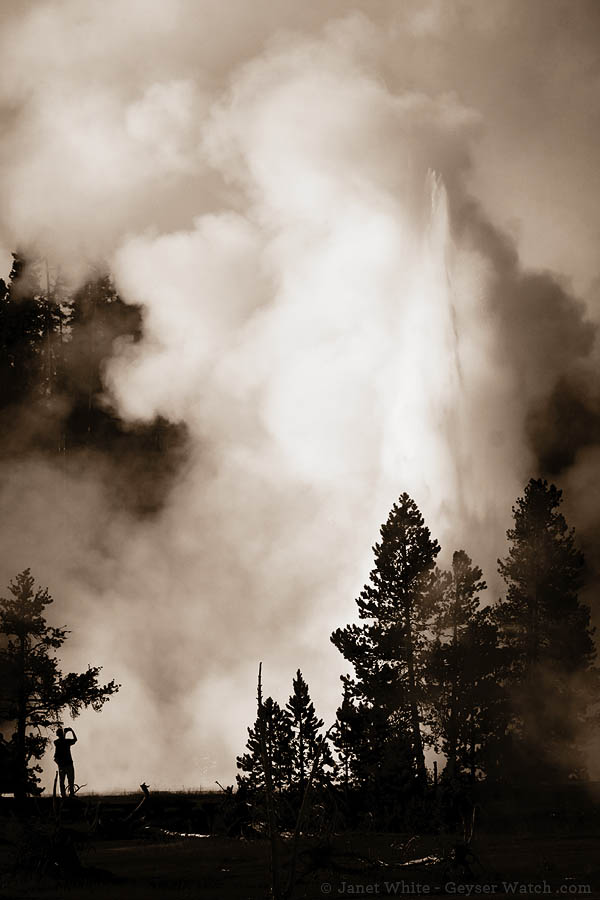 A Yellowstone Park visitor enjoys a second burst from Grand Geyser. (©Janet White - click to enlarge)