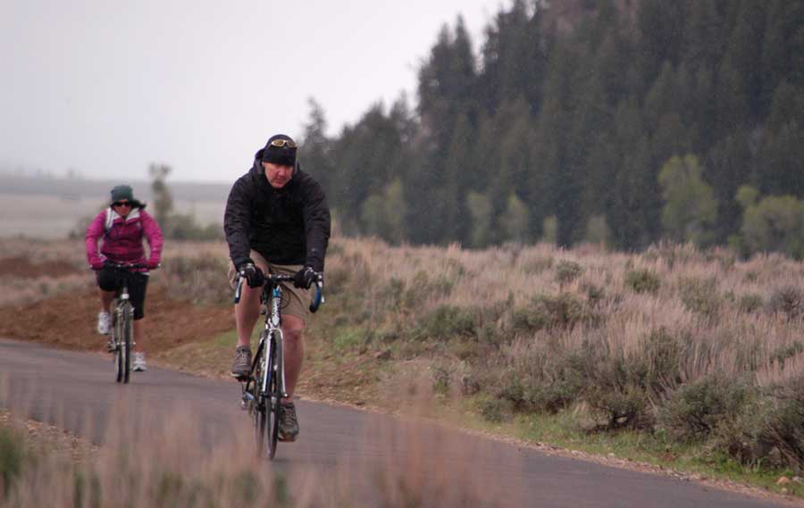 Bicyclists pedal through a mix of snow and freezing rain  south of Moose Wednesday on a newly opened segment of the multipurpose pathway in Grand Teton National Park. (Ruffin Prevost/Yellowstone Gate - click to enlarge)