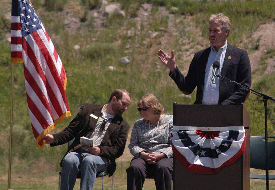 Bill Berg speaks during the Gardiner Gateway Project launch in Gardiner, Mont., sharing the stage with Daniel Bierschwale, President, Gardiner Chamber of Commerce and Clara Conner, Division Engineer, Western Federal Lands Highway Division. (Yellowstone Gate/Ruffin Prevost - click to enlarge)