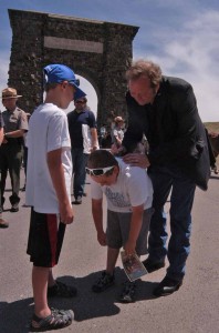 Montana Gov. Brian Schweitzer signs autographs for Landon Guengerich, 7, and Evan Guengerich, 9, left, in front of the Roosevelt Arch in Yellowstone National Park. (Ruffin Prevost/Yellowstone Gate - click to enlarge)