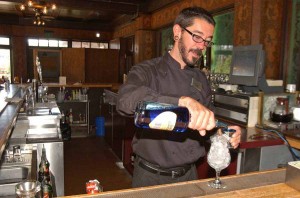 Topher Reimers tends bar at the Bear Pit in the Old Faithful Inn in Yellowstone National Park. Reimers had worked for six years in the park when this photo was taken in June 2006. (Ruffin Prevost/Yellowstone Gate file photo)