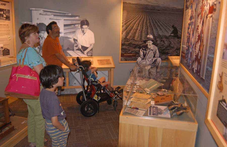 Brooke Wayne, left, Yuji Tsuno and their sons St. John, left, and Ruffin visit the Heart Mountain Interpretive Center east of Yellowstone National Park. (Ruffin Prevost/Yellowstone Gate - click to enlarge)