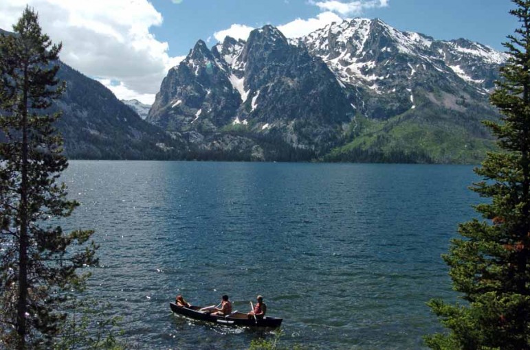 A group paddles a canoe on Jenny Lake in Grand Teton National Park. (Ruffin Prevost/Yellowstone Gate file photo - click to enlarge)