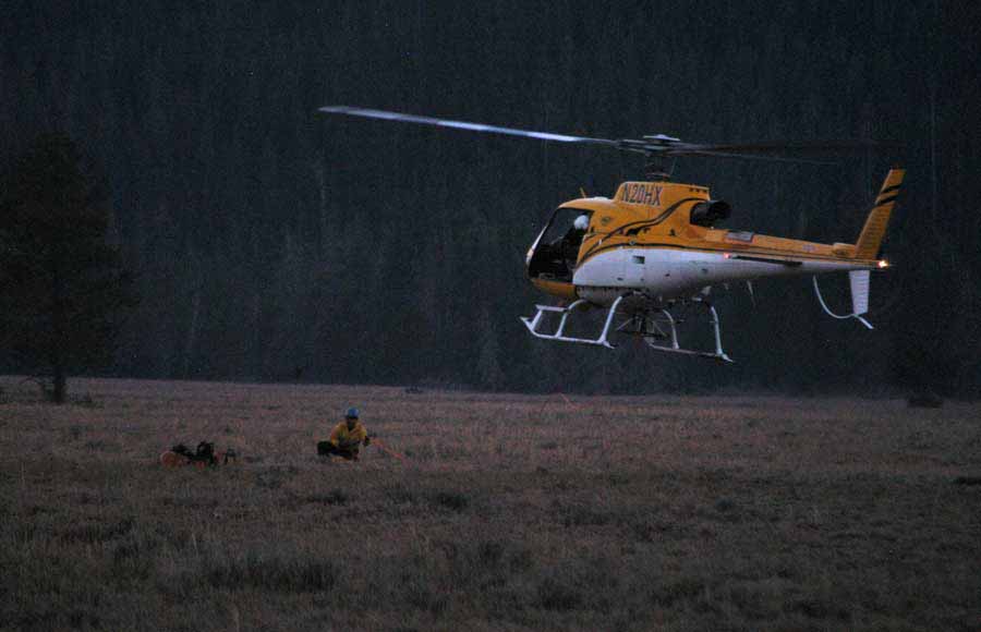 A search and rescue helicopter lands at the Jenny Lake rescue cache near Lupine Meadows in Grand Teton National Park in summer 2012 after completing a short-haul extraction of an imperiled climber from the Teewinot Mountain area. (Yellowstone Gate file photo/Ruffin Prevost)