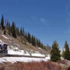 A motorcycle passes between the base of Talus Slope and the Lewis River in Yellowstone National Park. (Yellowstone Gate file photo/Ruffin Prevost - click to enlarge)