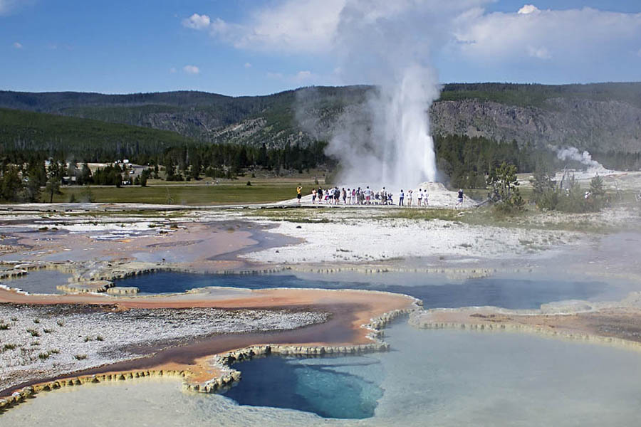 Visitors on Geyser Hill near Old Faithful in Yellowstone National Park watch an eruption of Lion Geyser. (Janet White/Geyser Watch - click to enlarge)