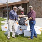 Jim McCaleb, left, general manager of Xanterra Parks & Resorts' Yellowstone operations, presents packpacks full of school supplies in Gardiner, Mont. (courtesy photo)