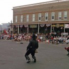 A crowd watches from the porch of the Irma Hotel in Cody as three villains are shot in a mock gunfight. (Ruffin Prevost - Yellowstone Gate file photo - click to enlarge)