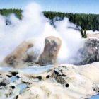 A postcard by historic Yellowstone National Park photographer Frank Haynes shows Grotto Geyser as it appeared in approximately 1913. (click to enlarge)