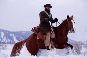 Actor Jamie Foxx rides a horse in front of what appears to be ski runs from the Snow King Resort in Jackson, Wyo., in the background. (©Columbia Pictures - click to enlarge)