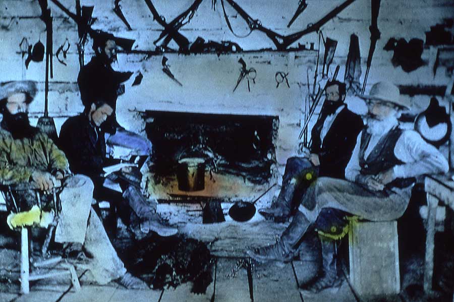 Yellowstone National Park's first commercial guide, Gilman Sawtell, far left, sits inside his cabin. (William Henry Jackson photo from the Yellowstone Digital Archive - click to enlarge)