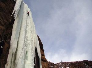 Aaron Mulkey of Cody climbs along a frozen waterfall in the South Fork Valley, near Cody. Discovered by Mulkey and named "The Testament," the climb covers a 180-foot pillar of ice supported only at the top where it leaves a cliff and the bottom where it reaches the ground. (File photo by Joel Anderson - click to enlarge)