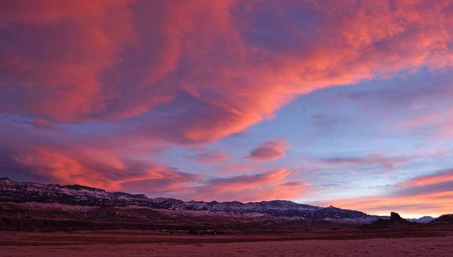 The sun sets over Carter Mountain with Castle Rock visible on the right in the South Fork Valley near Cody, Wyo. (Ruffin Prevost/Yellowstone Gate - click to enlarge)