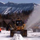 Workers look on as two rotary snowplows enter Yellowstone National Park on Monday to begin removing snow along the East Entrance Road. (Ruffin Prevost/Yellowstone Gate - click to enlarge)