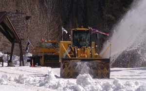 A rotary snowplow flying flags from the state of Wyoming and city of Cody removes snow from the East Entrance road of Yellowstone National Park on Monday. (Ruffin Prevost/Yellowstone Gate - click to enlarge)