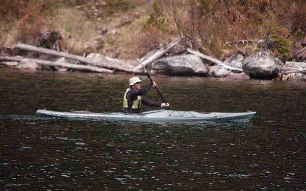 A kayaker paddles near the shore of Jenny Lake in Grand Teton National Park. (Ruffin Prevost/Yellowstone Gate)