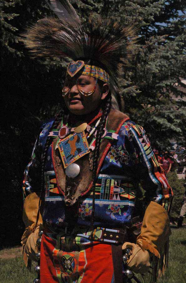 Jayce Old Coyote, 13, of Ethete, Wyo., takes a rest after the Grand Entry on Saturday during the 32nd Plains Indian Pow Wow at the Buffalo Bill Center of the West in Cody, Wyo. (Ruffin Prevost/Yellowstone Gate)