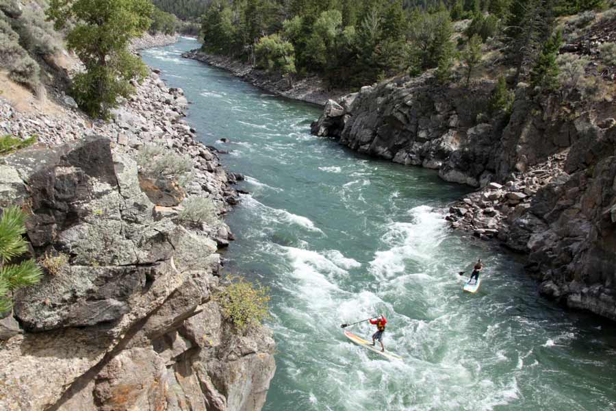 Two adventurers try their luck on stand-up paddleboards in Yankee Jim Canyon, north of Gardiner, Mont. (Montana Tourism photo)