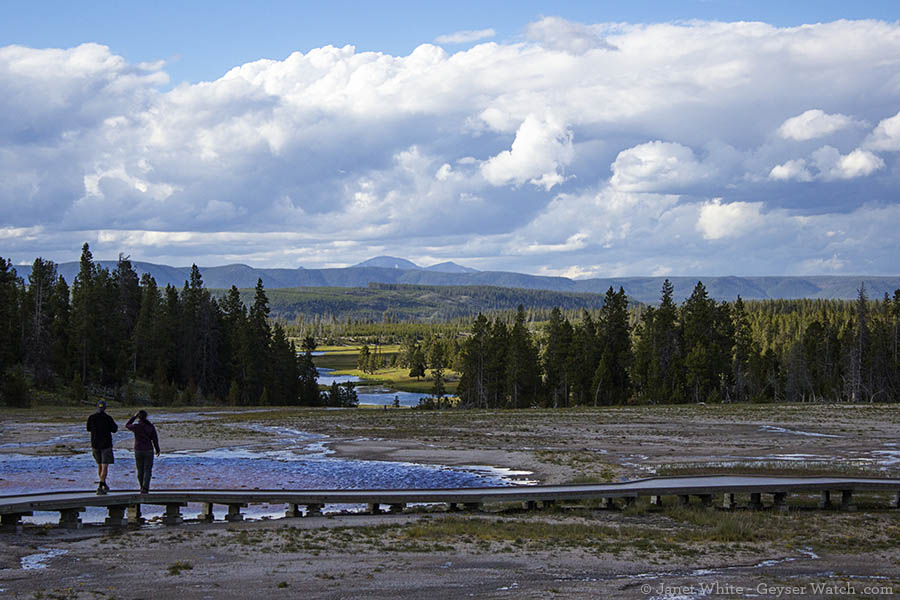 Visitors to Midway Geyser Basin pause and enjoy the view farther out in Yellowstone.