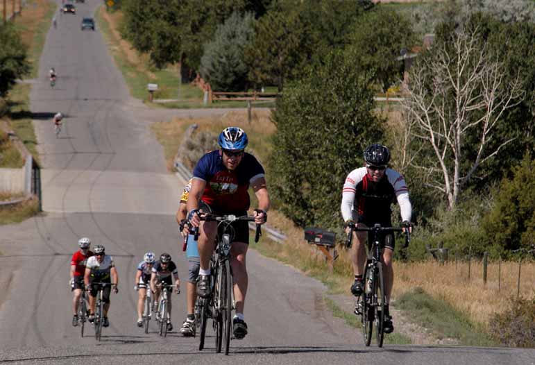 Bicyclists climb a hill along the Lower South Fork Road southwest of Cody, Wyo. during Cycle Greater Yellowstone last week.