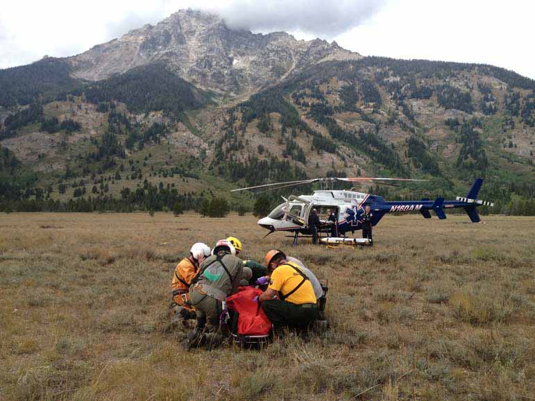 Rescue workers in Grand Teton National Park tend to climber Phil White after he was caught in a rockslide in Garnet Canyon.