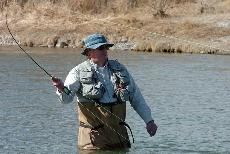 Fly-fisherman Jim Harris of Billings casts his line on the Shoshone River near the northern edge of Cody in this March 2009 file photo. Temperatures in the mid-60s lured many other fishermen to the water, which is fed by hot springs as it flows through town.
