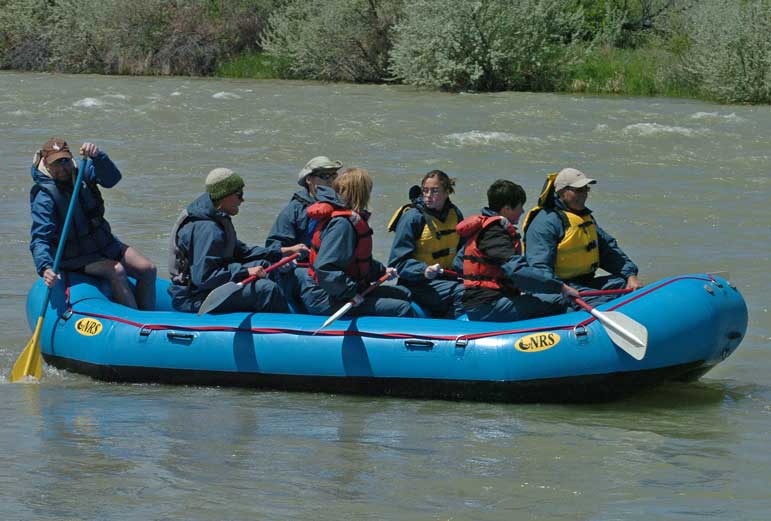 River Runners guide Larry Boyles, far left, launches a raft full of whitewater seekers into the middle of the Shoshone River, near the Belfry Highway bridge at the north edge of Cody, Wyo. in this June 2008 file photo.