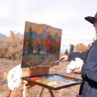 Idaho resident Elesa Shuman paints the Tetons amid fall colors as viewed from the Dornan's parking lot in Grand Teton National Park in this October 2012 file photo.