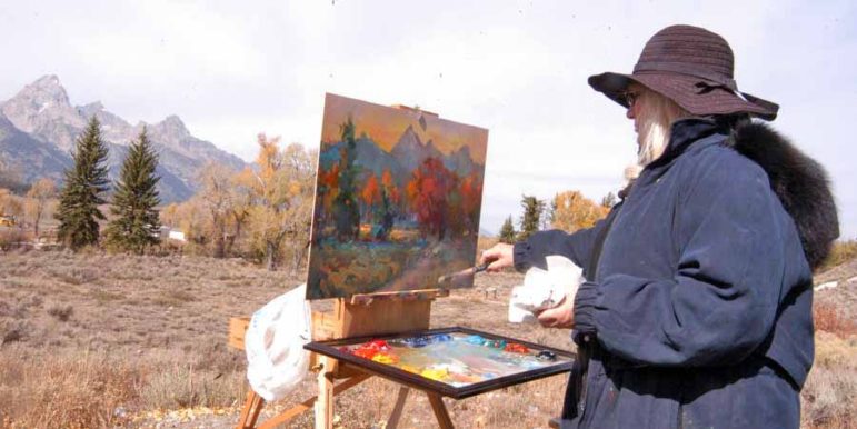 Idaho resident Elesa Shuman paints the Tetons amid fall colors as viewed from the Dornan's parking lot in Grand Teton National Park in this October 2012 file photo. 