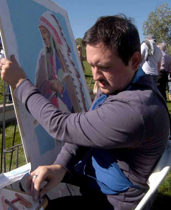 Blake Neubert creates a pastel portrait from a historical photo by Edward S. Curtis on Saturday during the Buffalo Bill Art Show Quick Draw in Cody, Wyo.