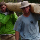 Participants in the Grand Teton National Park Youth Conservation Program move a log during a trail project.