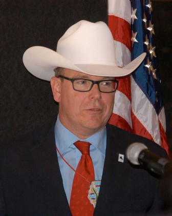 Prince Albert I of Monaco tries on a Stetson hat given to him Thursday during a luncheon in Cody, Wyo. to celebrate the launch of the Camp Monaco Prize. Named after a 1913 hunting trip attended by Prince Albert I and William F. "Buffalo Bill" Cody, the prize will fund research and education about biodiversity in the greater Yellowstone area. (Ruffin Prevost/Yellowstone Gate)