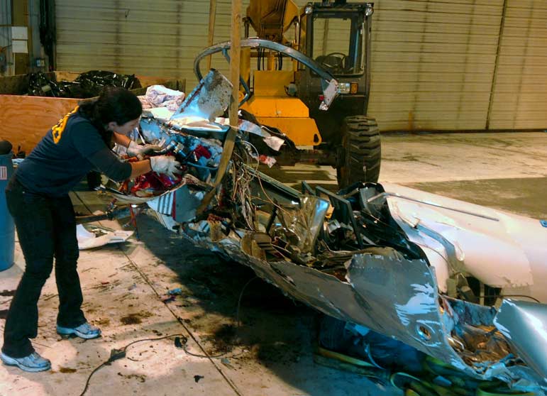 National Transporation Safety investigator Zoë Keliher from Boise, Idaho inspects wreckage of the RV7 aircraft that crashed in Grand Teton National Park on Wednesday.