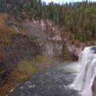 Mist from Upper Mesa Falls in the Caribou-Targhee National Forest in Idaho keeps the surrounding area green despite fall colors emerging across the region.