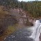 Mist from Upper Mesa Falls in the Caribou-Targhee National Forest in Idaho keeps the surrounding area green despite fall colors emerging across the region.