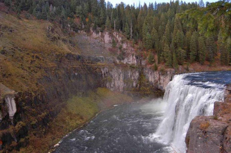 Mist from Upper Mesa Falls in the Caribou-Targhee National Forest in Idaho keeps the surrounding area green despite fall colors emerging across the region.