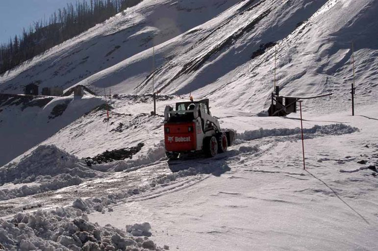 A National Park Service maintenance worker clears a path through early snow last month to allow for deployment of a howitzer used for avalanche mitigation in Yellowstone National Park. (Ruffin Prevost/Yellowstone Gate)