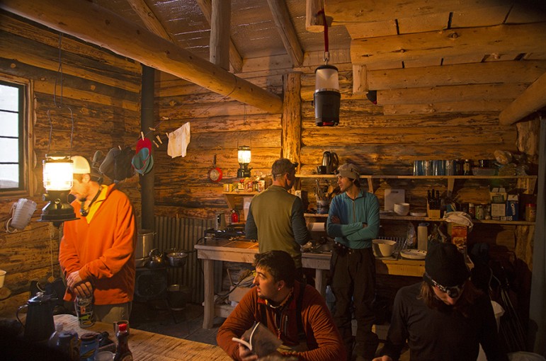 The interior of the Woody Creek Cabin near Cooke City, Mont. is heated by wood stove. Snow is melted for and meals are cooked on a propane stove. 
