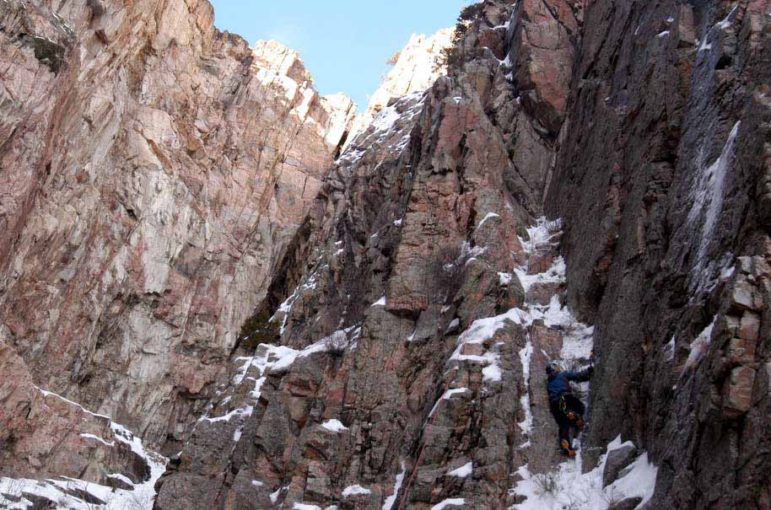 A climber looks for the best route up a rock face in Shoshone Canyon on Saturday during the 16th Annual Cody Ice Climbing Festival in Cody, Wyo.